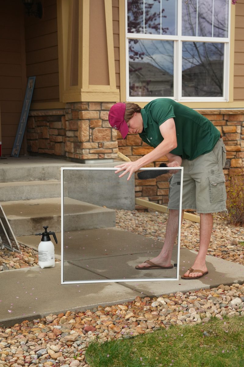 Window screen being hand-washed on site